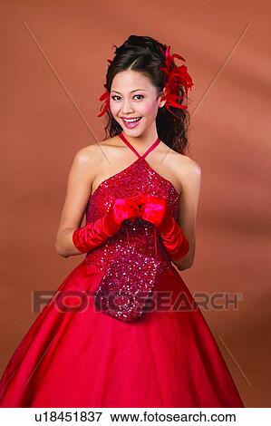 Stock Photo - Evening Wear, Three-Quarter Length, Brown, Indoor, Looking At Camera. Fotosearch