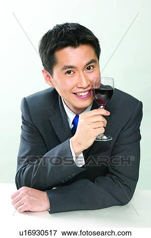 Stock Photo - Formal Clothing, Waist-Up, Party, Well-Dressed, Wineglass, Alcohol, Close-Up. Fotosearch