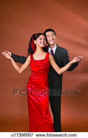 Stock Photo - Indoor, Dress, Evening Wear, Affectionate, Colored Background. Fotosearch