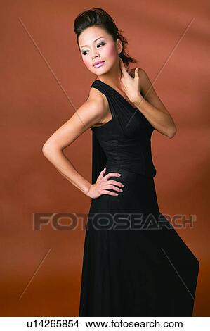 Indoor, Hand On Hip, Standing, Fashion, Asian Ethnicity, Looking Down, Posing View Large Photo Image Picture - Indoor, Hand On Hip, Standing, Fashion, Asian Ethnicity, Looking Down, Posing. Fotosearch