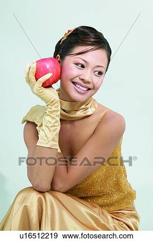 Stock Photo - One Young Woman Only, Party Dress, Looking Down, Evening Gown, Dress, Lifestyles. Fotosearch