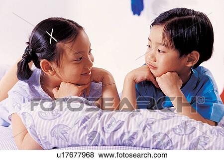 Stock Photo - 7-8 years, bed room, asian ethnicity, 5-6 years. Fotosearch