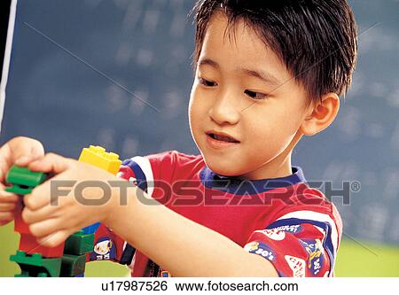Stock Photograph - asian ethnicity, cheerful, blocks, 5-6 years. Fotosearch