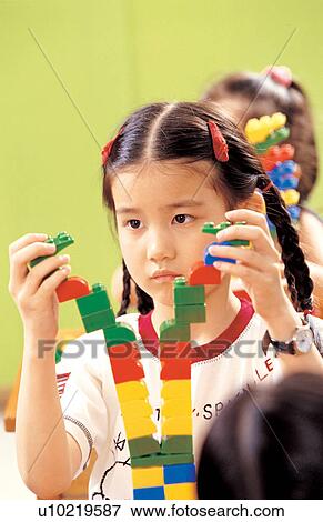 Stock Photo - asian ethnicity, child, blocks, 7-8 years. Fotosearch