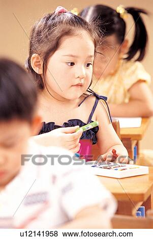 Stock Photo - book, art, 5-6 years, children, culture, childhood, looking down. Fotosearch