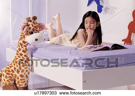 Stock Image - childhood, open, bed room, looking down, toy, young. Fotosearch