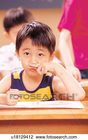 Stock Image - color stick, hand on face, learning, education, young. Fotosearch