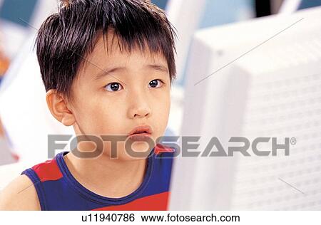 Stock Photograph - computer class, knowledge, looking at computer, childhood, head and shoulders, young. Fotosearch