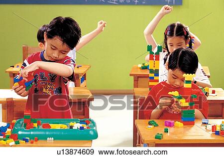 Stock Photo - culture, hand in air, close up, building blocks, head and shoulders, game, school boys. Fotosearch