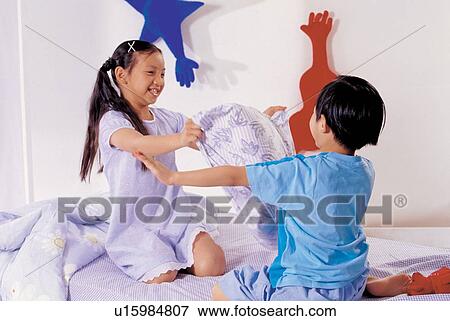 Stock Photo - indoor, 7-8 years, lifestyle, fighting, sitting, children. Fotosearch