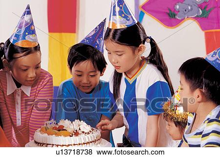 Stock Photo - joy, enjoyment, occasion, indoor, birthday caps, half length. Fotosearch