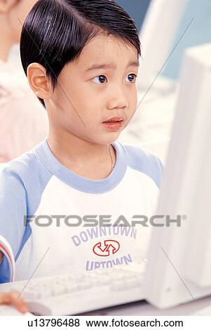 Stock Photo - learning, asian ethnicity, childhood, classroom, computer class, boy. Fotosearch