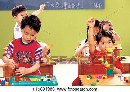 Stock Image - learning, indoor, boy, education, playful, looking down. Fotosearch