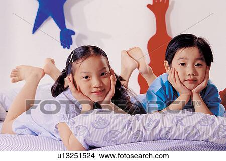 Picture - playful, child, 7-8 years, looking at camera, room. Fotosearch
