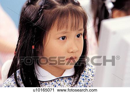 Stock Image - young, indoor, childhood, sitting, screen, education. Fotosearch