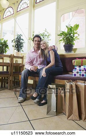 Couple relax in pub after shopping View Large Photo Image Stock Image - Couple relax in pub after shopping. Fotosearch