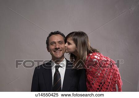 Daughter (9-11) kissing smiling father on cheek View Large Photo Image Stock Photography - Daughter (9-11) kissing smiling father on cheek . Fotosearch