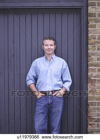 Stock Photograph - Man leaning against door. Fotosearch