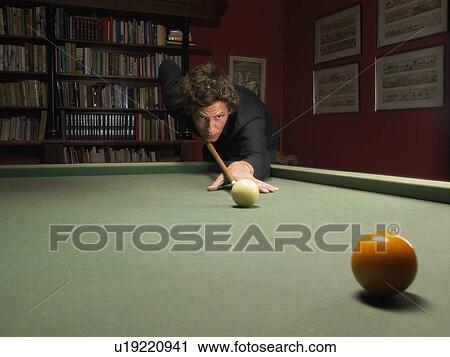 Stock Image - Man playing snooker. Fotosearch
