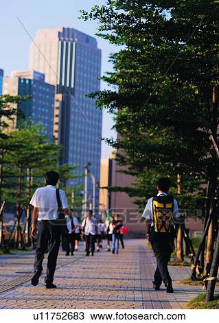 Stock Image - building, pavement, tree, hour, walking. Fotosearch