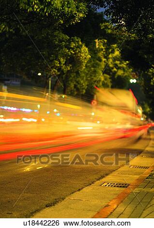 Stock Photograph - city, light, transportation, moving, tree, hour. Fotosearch