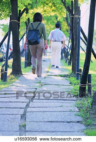 Stock Photograph - hour, tree, pavement, transportation, people, walking. Fotosearch