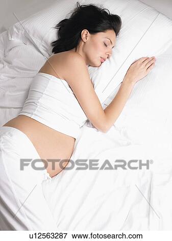 Pregnant woman sleeping View Large Photo Image Stock Photo - Pregnant woman sleeping. Fotosearch