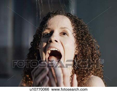 Woman beneath shower, smiling View Large Photo Image Stock Photograph - Woman beneath shower, smiling. Fotosearch