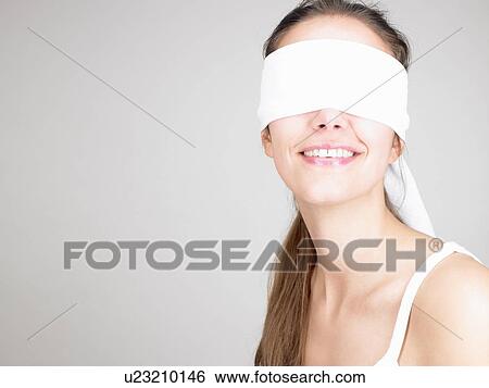Woman blindfolded, smiling View Large Photo Image Stock Photograph - Woman blindfolded, smiling. Fotosearch