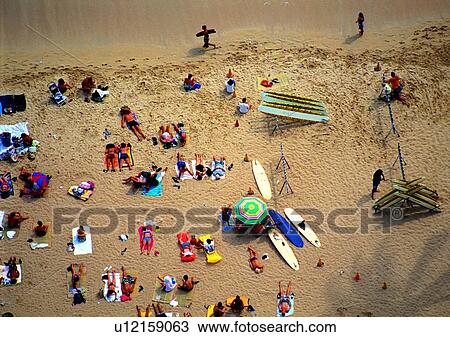 Stock Image - scenery, surfboard, shore, coast, people, ocean, beach umbrella. Fotosearch