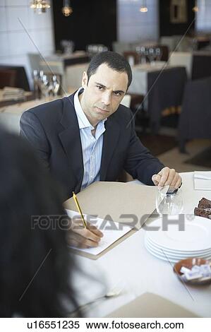 Stock Photography - Business man in meeting in restaurant. Fotosearch