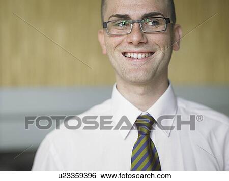 Businessman in an office View Large Photo Image Stock Photograph - Businessman in an office. Fotosearch