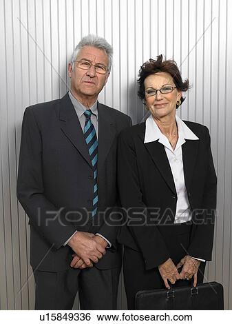 Businesspeople by a silver wall. View Large Photo Image Stock Photograph - Businesspeople by a silver wall.. Fotosearch