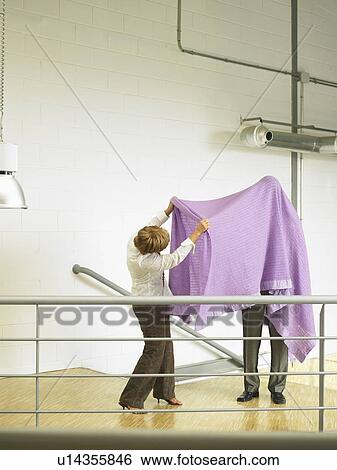 Businesspeople under a blanket View Large Photo Image Stock Photograph - Businesspeople under a blanket. Fotosearch
