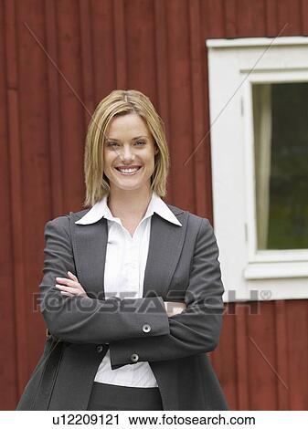 Businesswoman by country cottage smiling View Large Photo Image Stock Image - Businesswoman by country cottage smiling. Fotosearch