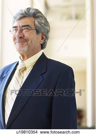 Picture - Senior businessman wearing spectacles, smiling. Fotosearch