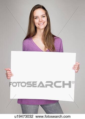 Woman carrying a notice, smiling View Large Photo Image Stock Image - Woman carrying a notice, smiling. Fotosearch