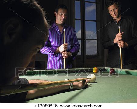 Stock Photograph - Men playing snooker. Fotosearch