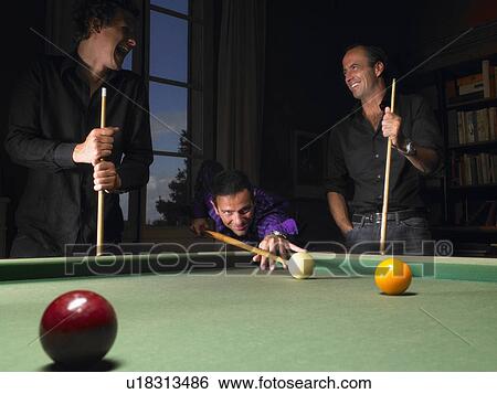 Stock Photograph - Men playing snooker. Fotosearch