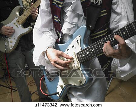 Stock Image - Two electric guitar players in studio close up.. Fotosearch