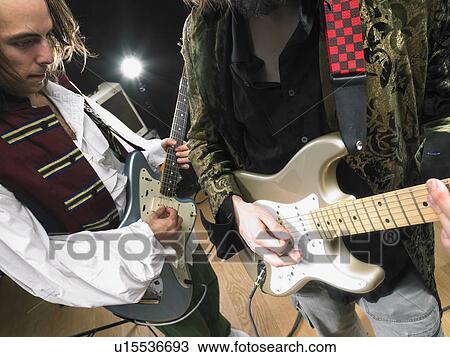 Stock Image - Two electric guitar players in studio.. Fotosearch