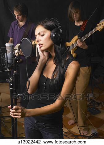 Woman singing in a band. View Large Photo Image Stock Image - Woman singing in a band.. Fotosearch
