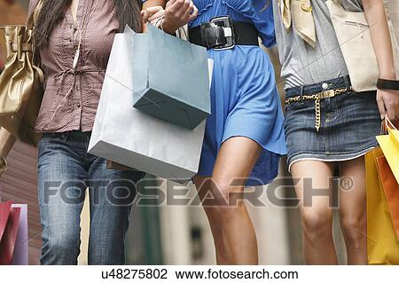 Young women walking with shopping bags View Large Photo Image Stock Image - Young women walking with shopping bags. Fotosearch