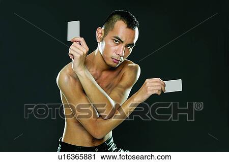 Stock Image - Bare Chest, Close-Up, Black Hair, Black Background, Asian Ethnicity. Fotosearch