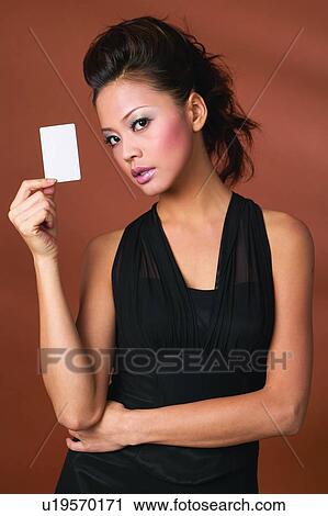 Stock Image - Black Hair, Colored Background, Close-Up, Asian Ethnicity. Fotosearch