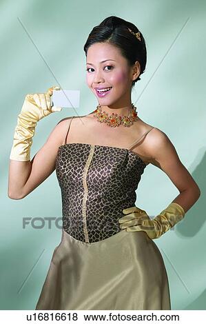 Stock Photo - Evening Gown, Young Adult, Asian Ethnicity, Holding, Close-Up. Fotosearch