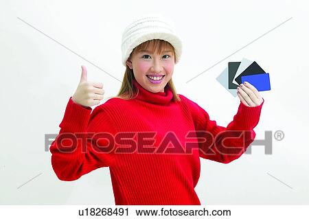 Stock Image - Toothy Smile, Lifestyles, Portrait, Young Adult, Good News, Holding, Looking At Camera. Fotosearch