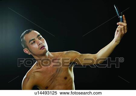 Stock Photography - Bare Chest, Chinese Ethnicity, Black Hair, Black Background, Asian Ethnicity. Fotosearch