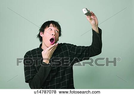 Stock Photo - Black Hair, Chinese Ethnicity, Checked, Casual Clothing, Asian Ethnicity. Fotosearch