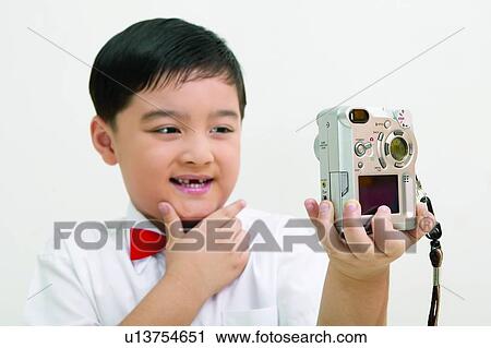 Stock Image - Child, Asian Ethnicity, Button Down Shirt, Bow Tie, Black Hair, Chinese Ethnicity, 10-11 Years. Fotosearch